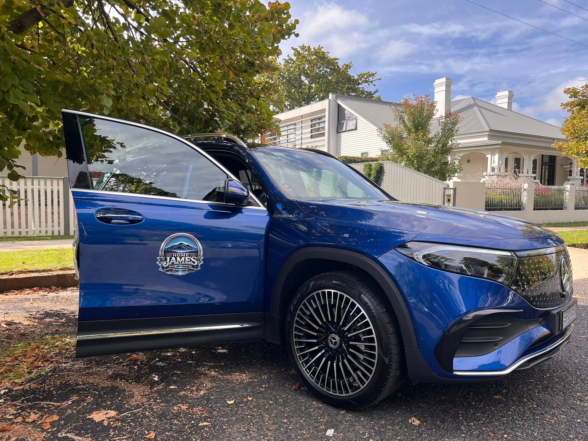 Home James Mercedes-Benz EQB250+ EV with branded door logo parked in Orange NSW — the luxury vehicle for private tours and transfers
