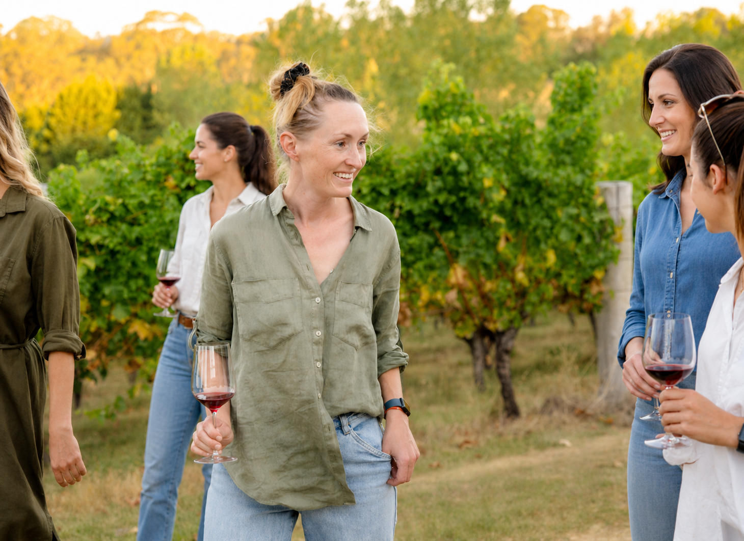 Women with wine glasses among the vines at ChaLou Wines, Orange NSW